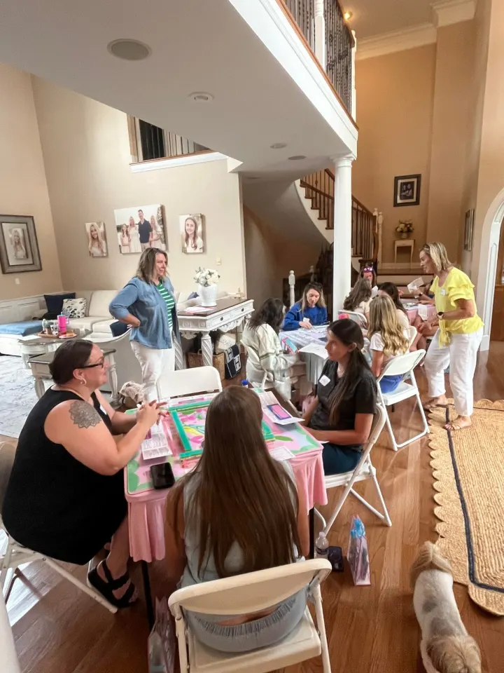 Guests gathered around multiple tables at a Mahjong party
